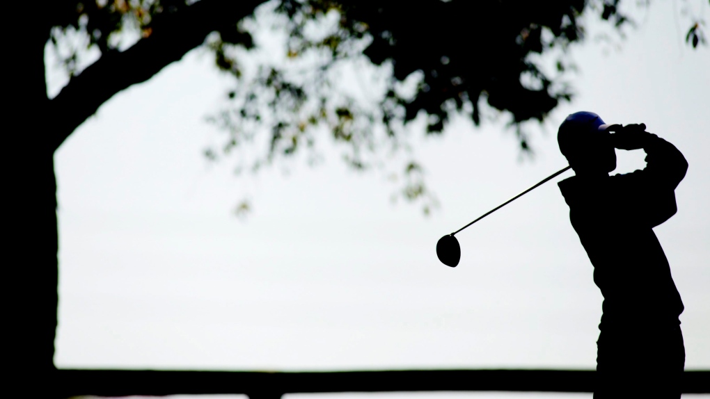 A golfer is silhouetted against the sky as he drives the ball in Bowling Green, Kentucky, in this October 2012 file photo. (AP Photo/The Daily News/Nathan Morgan)