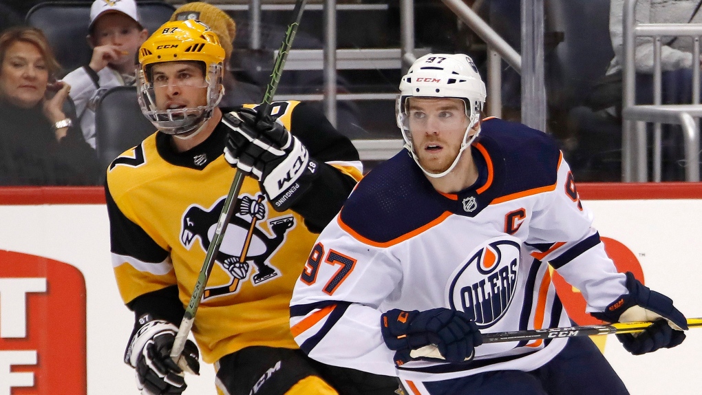 In this Nov. 2, 2019, file photo, Edmonton Oilers' Connor McDavid (97) and Pittsburgh Penguins' Sidney Crosby (87) skate during the second period of an NHL hockey game in Pittsburgh. (AP Photo/Gene J. Puskar, File) 