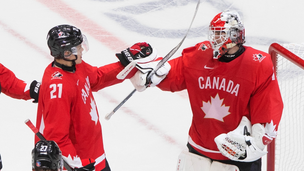Canada's Kaiden Guhle (21) and goalie Devon Levi (1) celebrate their win over the Czech Republic during IIHF World Junior Hockey Championship action in Edmonton on Saturday, January 2, 2021. THE CANADIAN PRESS/Jason Franson 