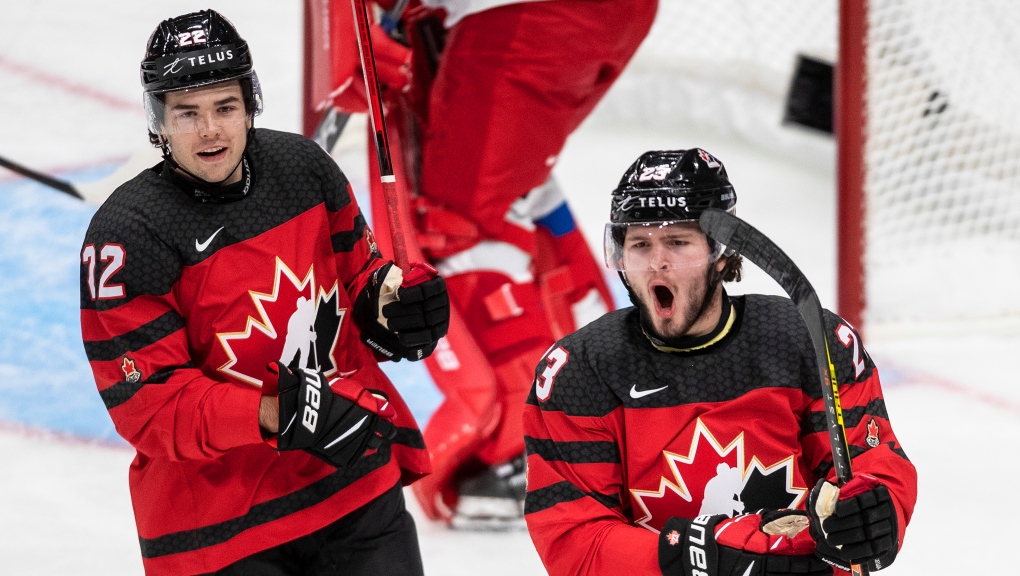 Canada's Jake Neighbours (12) and Mason McTavish (23) celebrate a goal against Russia during first period IIHF World Junior Hockey Championship exhibition action in Edmonton, Thursday, Dec. 23, 2021. Both Neighbours and McTavish had made their NHL debuts ahead of the tournament. THE CANADIAN PRESS/Jason Franson 