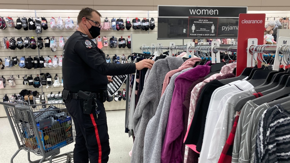 An Edmonton Police Service officer shopping for Christmas gifts on a local student's wish list. Dec. 8, 2021. (Brandon Lynch/CTV News Edmonton)