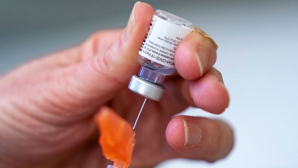 In this Saturday, April 10, 2021 photo, a syringe is loaded with the Pfizer-BioNTech COVID-19 vaccine at a clinic in Richmond, British Columbia, Canada. (Jonathan Hayward/The Canadian Press via AP)