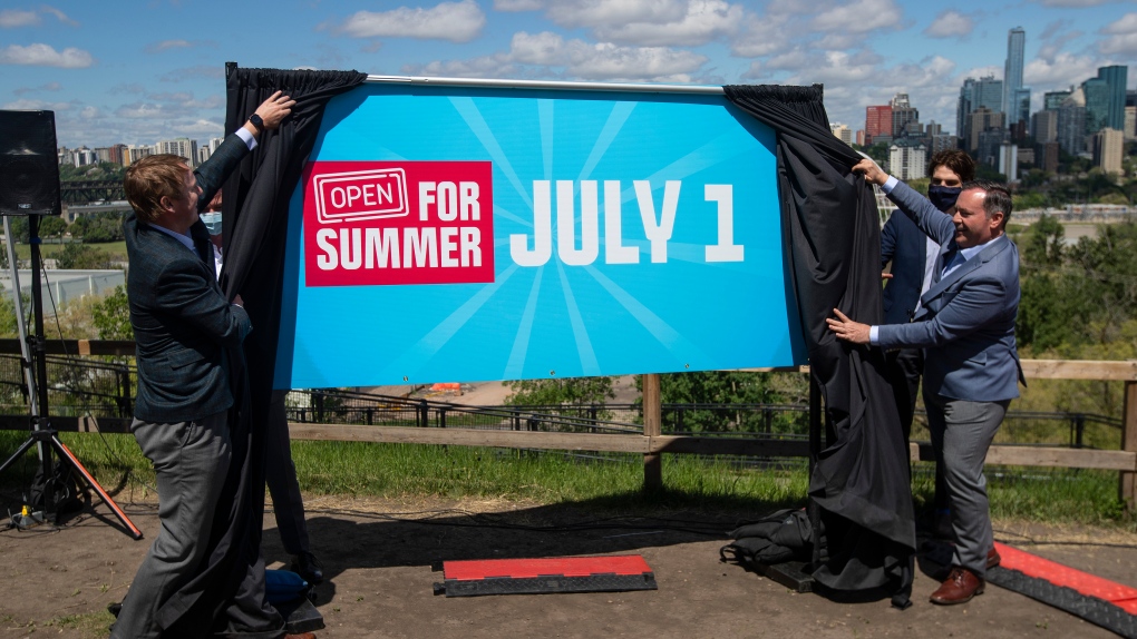 Albert Health Minister Tyler Shandro and Alberta Premier Jason Kenney unveil an opening sign after speaking about the Open for Summer Plan and next steps in the COVID-19 vaccine rollout, in Edmonton, Friday, June 18, 2021. THE CANADIAN PRESS/Jason Franson 