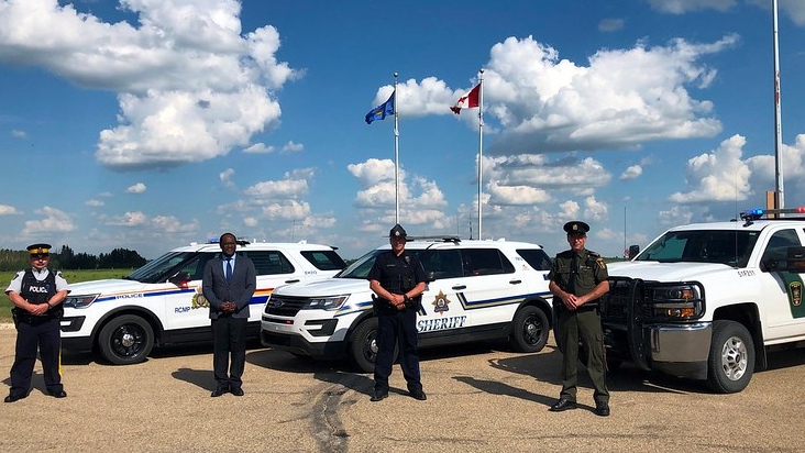 Justice Minister Kaycee Madu stands with RCMP Const. Scott Hearn, sheriff highway patrol officer Mike Overly, and fish and wildlife officer Andy Nestorovich (Source: Ministry of Justice and Solicitor General) 