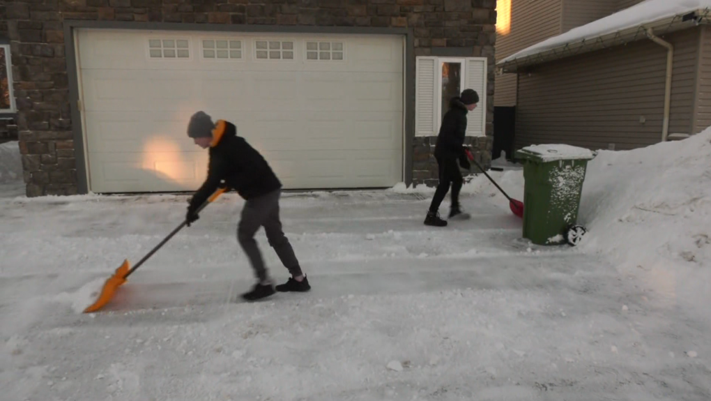 Teens at work shovelling for Frost Bite Snow Removal in Beaumont. 
