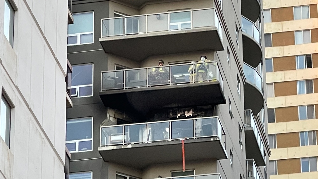 Firefighters assess damage after an apartment balcony fire on Monday, Oct. 3, 2022 (CTV News Edmonton/Sean McClune).