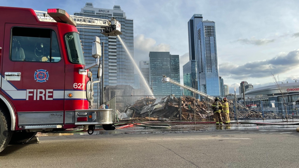 Fire crews douse flames at an abandoned building in downtown Edmonton on Sunday, April 10, 2022 (CTV News Edmonton/Sean McClune).