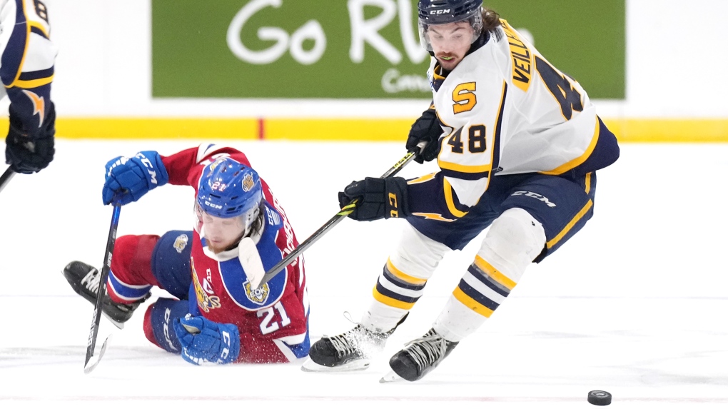 Edmonton Oil Kings' Jake Neighbours, left, loses an edge while fighting for the puck with Shawinigan Cataractes' William Veillette during the third period of Memorial Cup hockey action in Saint John, N.B. on Tuesday, June 21, 2022. THE CANADIAN PRESS/Darren Calabrese