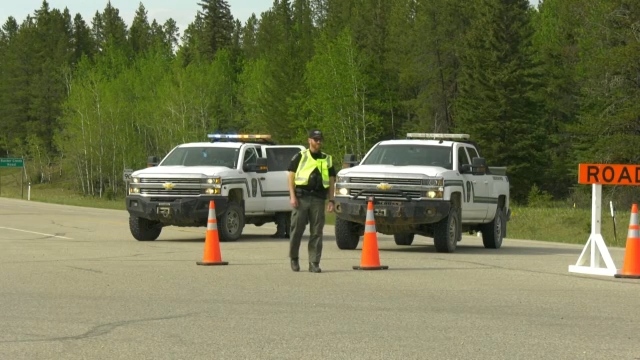 Alberta Fish and Wildlife officers block off access to Buster Creek Road near the Crimson Lake Provincial Park on Friday, May 3, 2022 due to a wildfire (CTV News/Nav Sangha).