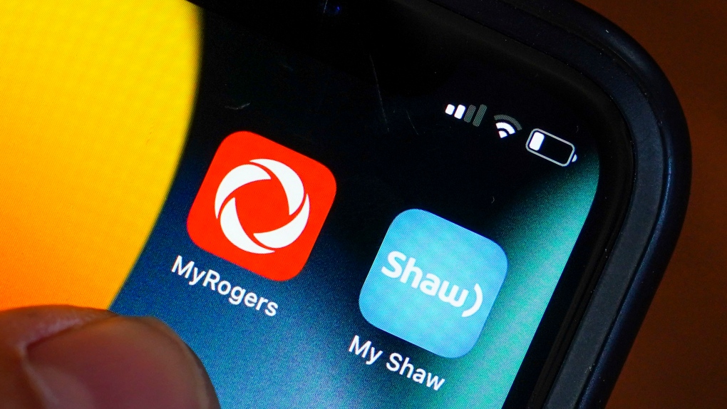 Rogers and Shaw applications are pictured on a cellphone in Ottawa on Monday, May 9, 2022. The Competition Bureau says is seeking to block Rogers Communications Inc.'s proposed $26-billion acquisition of Shaw Communications Inc.THE CANADIAN PRESS/Sean Kilpatrick