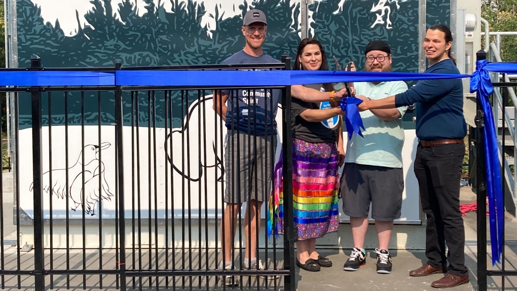 Artist Matthew James Weigel (center-right) said he wanted to create a piece of art that would center around the land that it was on, and incorporated the natural landscape into the piece. (CTV News Edmonton/Brandon Lynch)