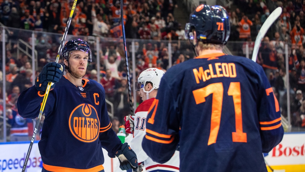 Edmonton Oilers' Connor McDavid (97) and Ryan McLeod (71) celebrate a goal against the Montreal Canadiens during second period NHL action in Edmonton on Saturday, March 5, 2022.THE CANADIAN PRESS/Jason Franson