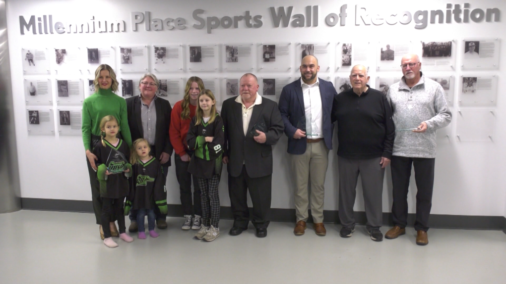 Inductees in front of the Millennium Place Sports Wall of Recognition in Strathcona County on Friday Jan. 13, 2023. (CTV News Edmonton/Sean McClune)