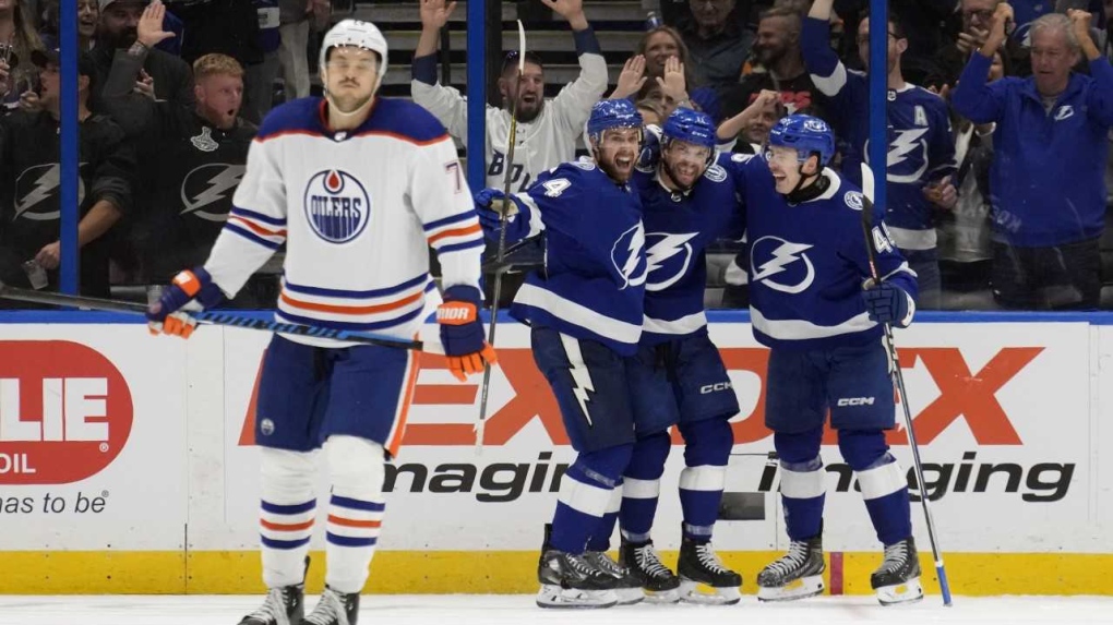 Tampa Bay Lightning center Luke Glendening (11) celebrates his goal against the Edmonton Oilers with defenseman Calvin de Haan (44) and left winger Cole Koepka (45) during the third period of an NHL hockey game Saturday, Nov. 18, 2023, in Tampa, Fla. (AP Photo/Chris O'Meara)
