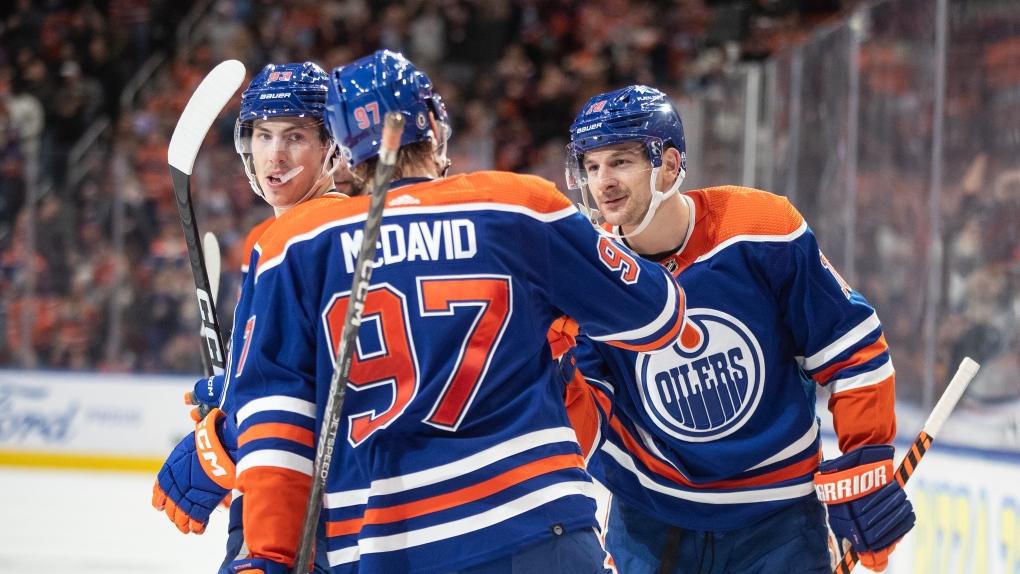Edmonton Oilers' Ryan Nugent-Hopkins (93), Connor McDavid (97) and Zach Hyman (18) celebrate a goal against the Anaheim Ducks during second period NHL action in Edmonton on Sunday November 26, 2023. THE CANADIAN PRESS/Jason Franson