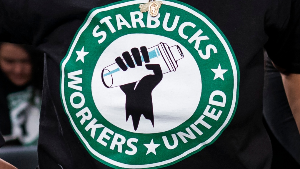 File - The Starbucks Workers United logo appears on the shirt of a person attending a hearing in Washington on March 29, 2023. Starbucks sued the union organizing its workers Wednesday, saying a pro-Palestine social media post from a union account early in the Israel-Hamas war angered hundreds of customers and damaged its reputation. (AP Photo/J. Scott Applewhite, File)