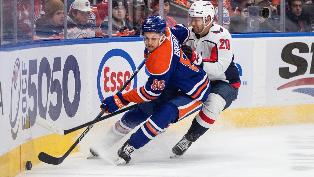 Washington Capitals' Lars Eller (20) and Edmonton Oilers' Philip Broberg (86) battle for the puck during first period NHL action in Edmonton, Monday, Dec. 5, 2022. THE CANADIAN PRESS/Jason Franson