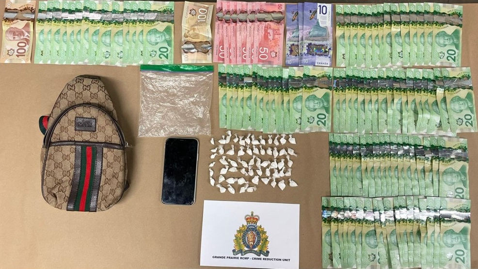 Photo showing the suspected cocaine and cash seized from an Edmonton man after a Grande Prairie traffic stop (Source: RCMP).