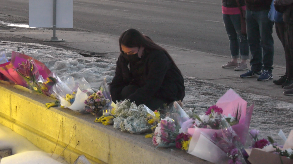 Mourner pays respects to Const. Travis Jordan and Const. Brett Ryan at the Edmonton Police Service West Division. 