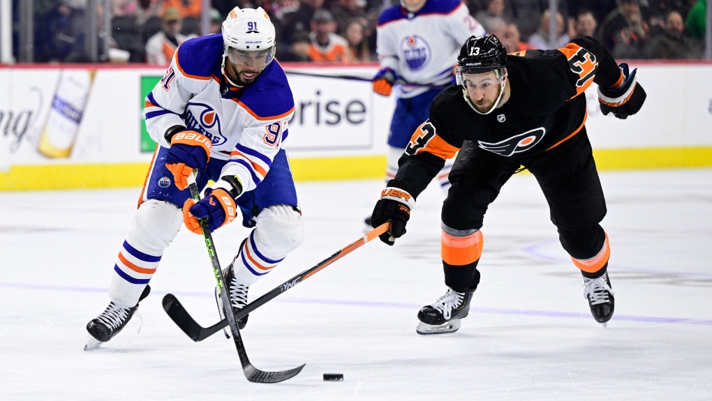 Edmonton Oilers' Evander Kane, left, tries to keep the puck from Philadelphia Flyers' Kevin Hayes during the third period of an NHL hockey game, Thursday, Feb. 9, 2023, in Philadelphia. (AP Photo/Derik Hamilton)