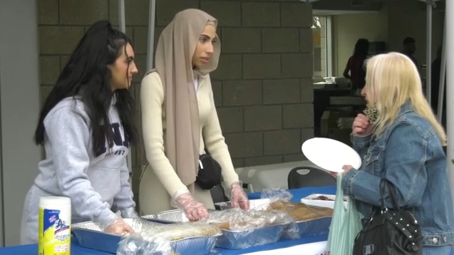 Volunteers hand out free burgers and hot dogs during Taste of Ramadan on Monday, April 10, 2023 (CTV News Edmonton/Sean McClune).