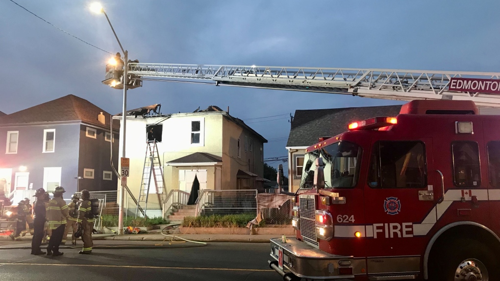 Firefighters work on a blaze at a boarded-up home near 95 Street and 110 Avenue in the early morning of May 25, 2023. 