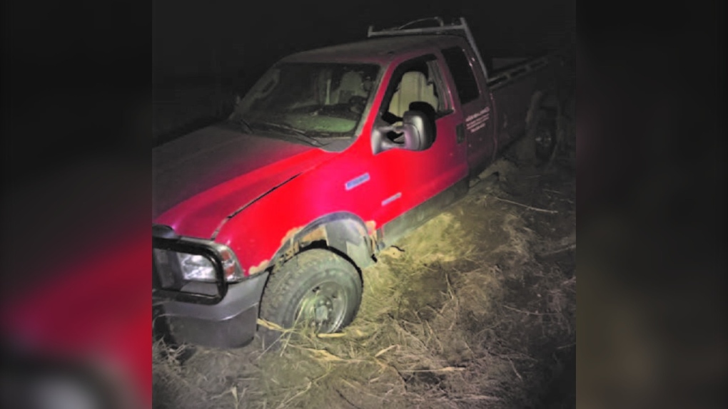 A man was arrested after he stole this truck and got stuck in a muddy field, Peace River RCMP said. (Credit: RCMP)