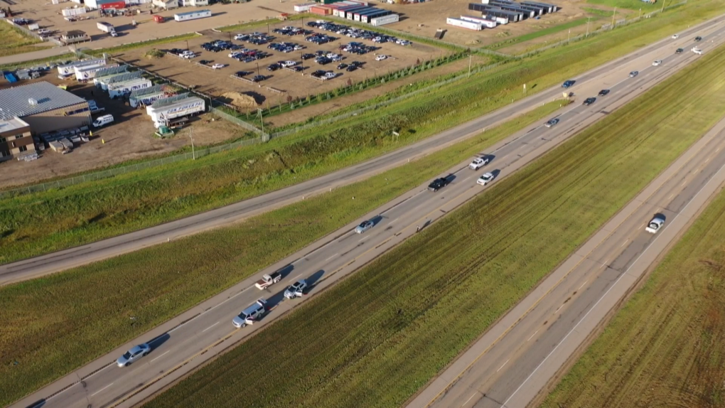 Traffic passes a crash scene on Highway 16 near Highway 60 in Alberta on July 31, 2023. 