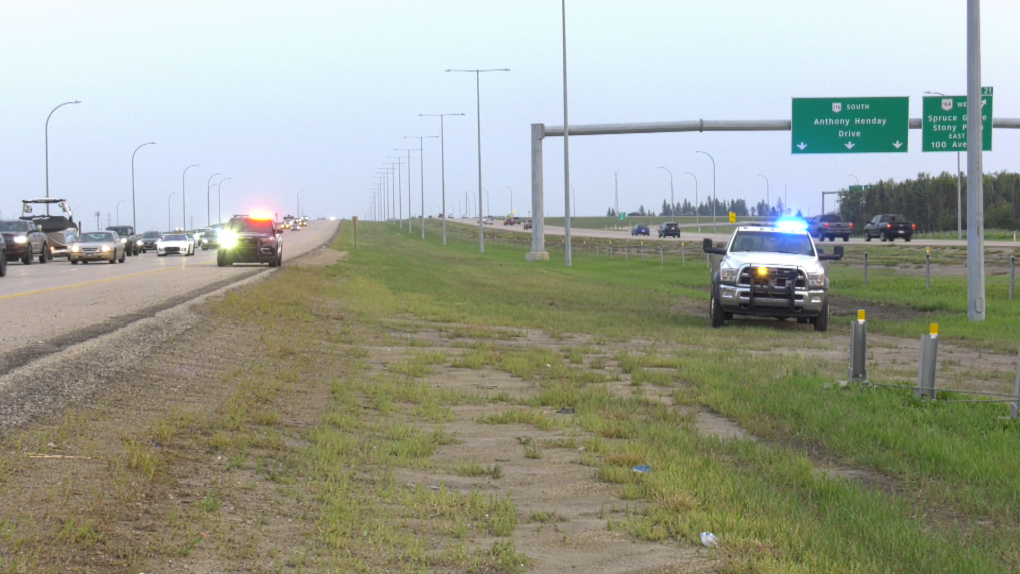 A tow truck operator removes a car from the median near 111 Avenue and Anthony Henday Drive in west Edmonton after a shooting on the ring road on Aug. 31, 2023. (CTV News Edmonton / Sean Amato) 