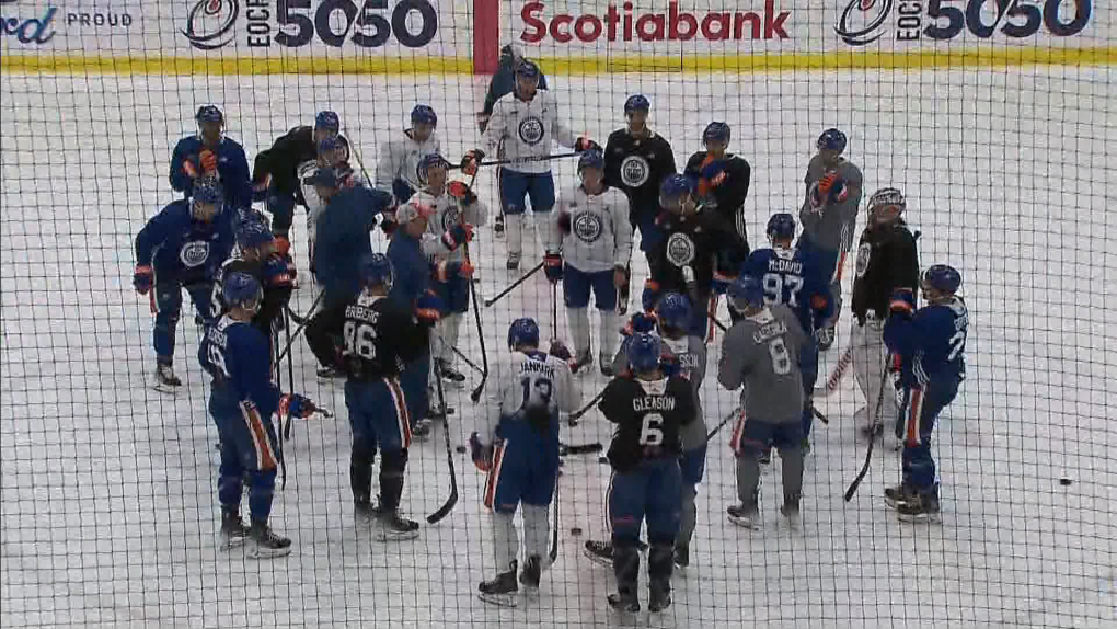 Edmonton Oilers players gather at centre ice on Sept. 25, 2022, during a training camp session at Edmonton's Downtown Community Arena. (CTV News Edmonton)