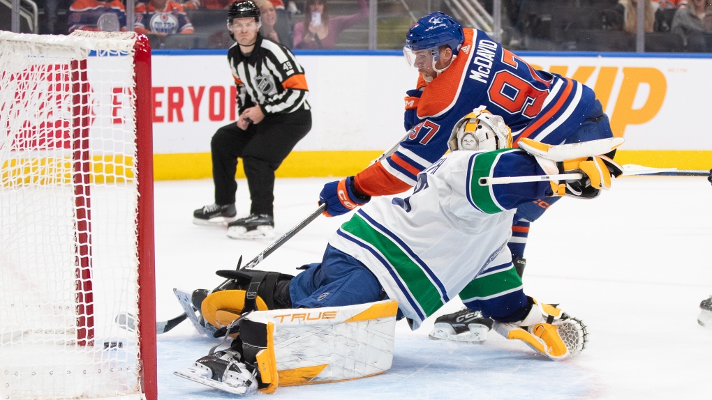 Vancouver Canucks' goalie Casey DeSmith (29) is scored on by Edmonton Oilers' Connor McDavid (97) during overtime NHL pre season action in Edmonton, Wednesday, Sept. 27, 2023. THE CANADIAN PRESS/Jason Franson