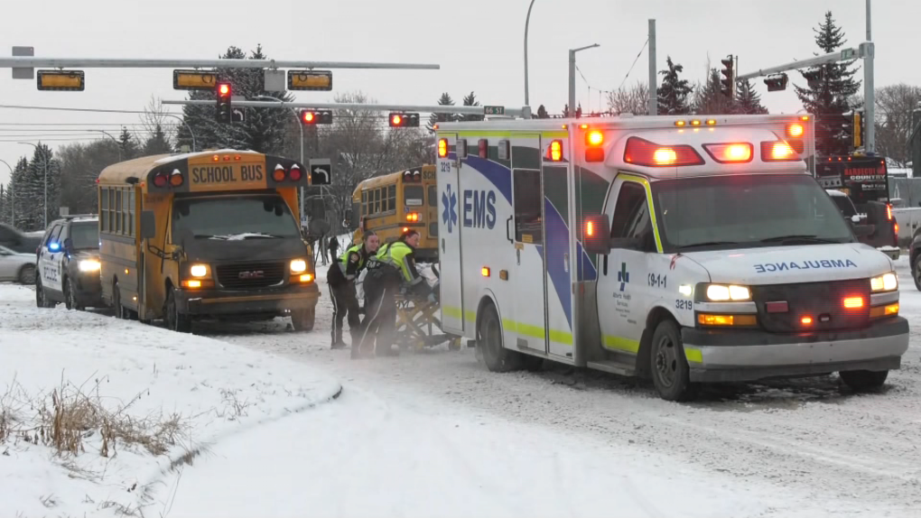 Paramedics load an adult into an ambulance at 66 Street and 38 Avenue on Feb. 5, 2024, following a collision between a school bus and a transit bus. (Brandon Lynch/CTV News Edmonton)