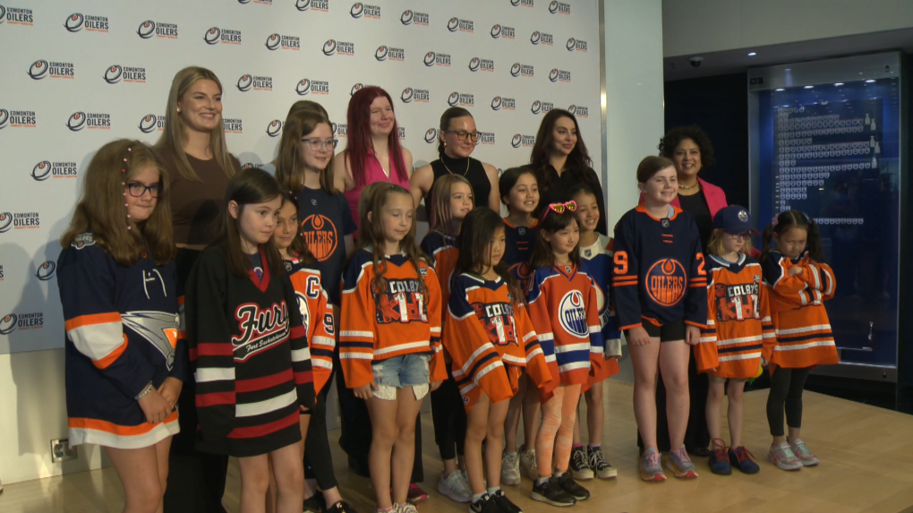 Danielle Serdachny (top-left) along with representatives of EOCF and Hockey Edmonton take a picture with a group of girls during the launch event of the Girls Hockey Initiative on July 18, 2024. (Bruce Wiggins/CTV News Edmonton)