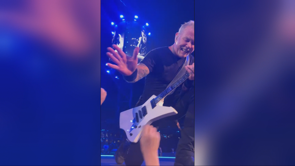 Metallica lead vocalist and guitarist James Hetfield high fives 13-year-old Xander Goltz during the band's concert in Edmonton on Aug. 23, 2024. (Credit: Ron Goltz)